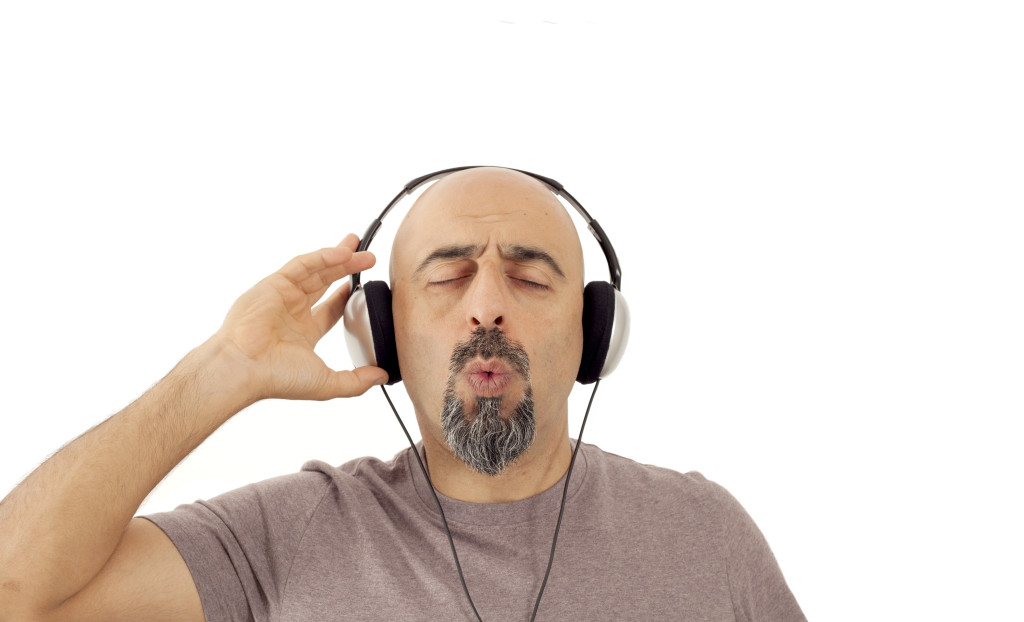 The man listening to the music and whistling